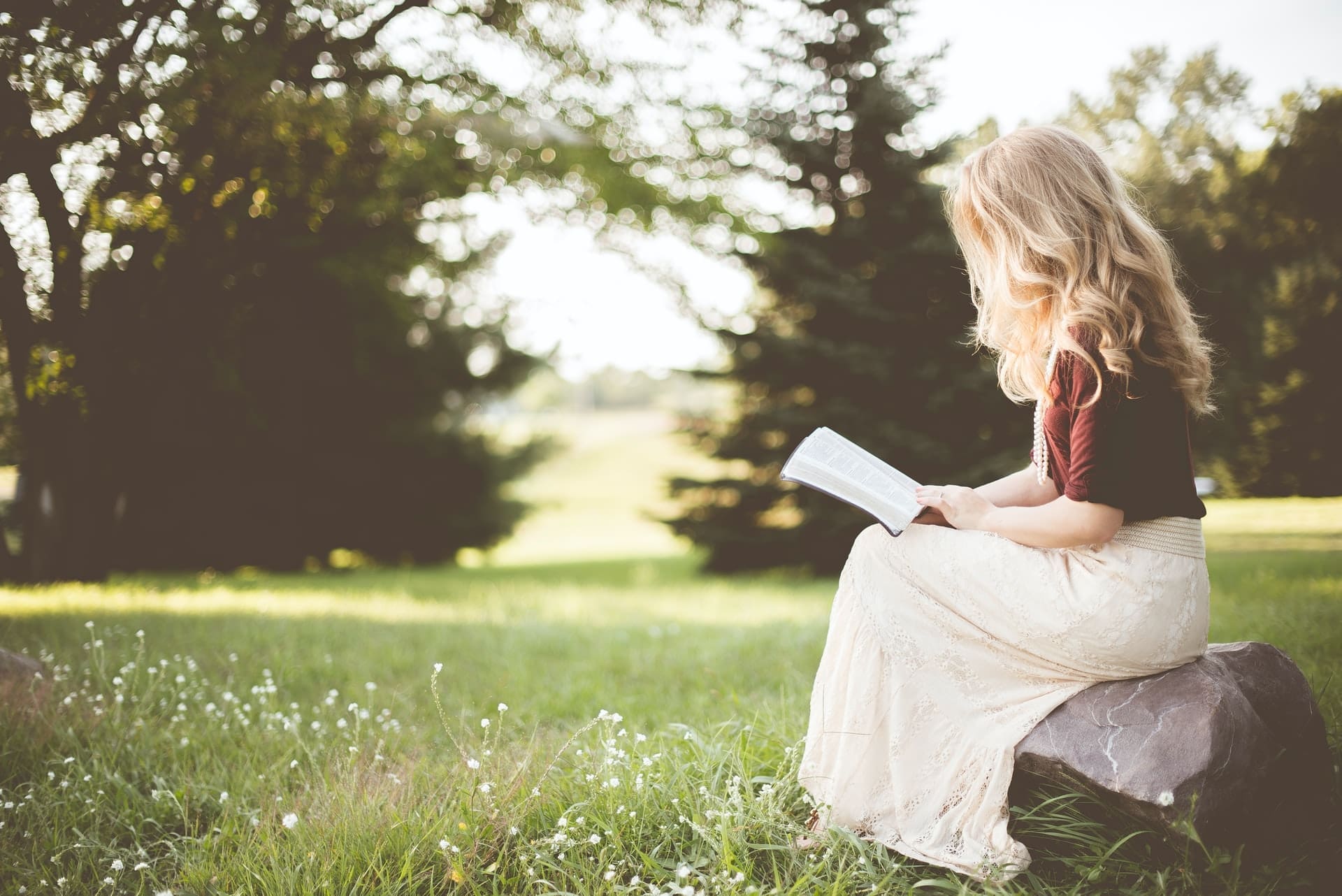 Woman outside reading the Bible